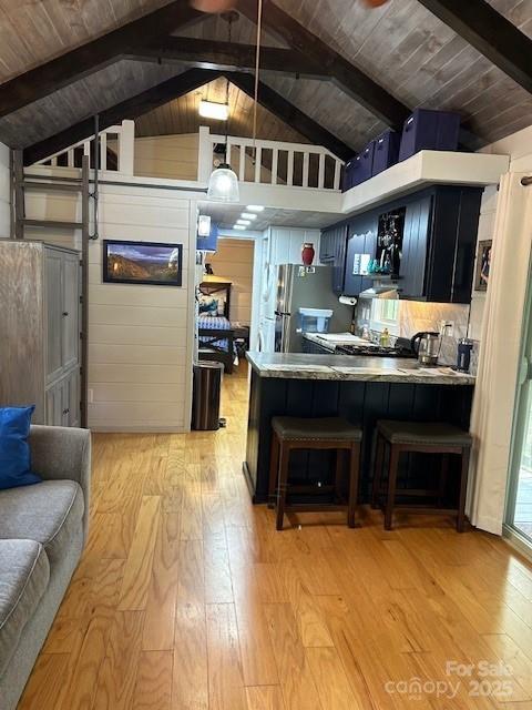 623 Overlook Dr, Spruce Pine, NC 28777 - kitchen featuring freestanding refrigerator, light wood finished floors, dark cabinetry, a breakfast bar, and wood ceiling