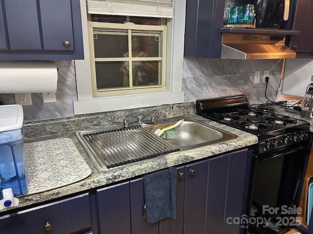 623 Overlook Dr, Spruce Pine, NC 28777 - kitchen featuring black gas stove, blue cabinets, under cabinet range hood, and backsplash