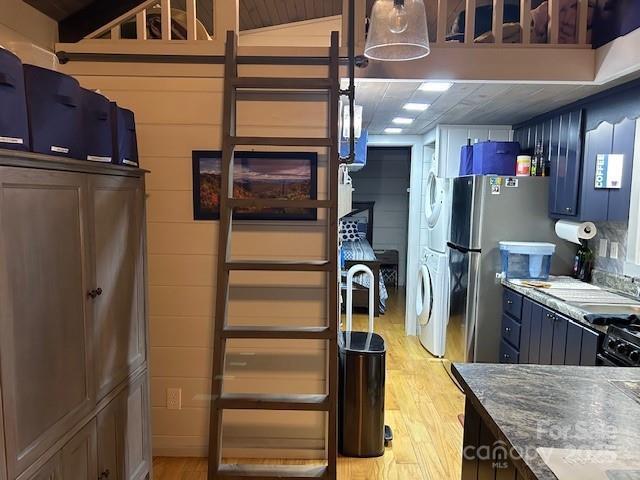 623 Overlook Dr, Spruce Pine, NC 28777 - kitchen featuring stacked washer / drying machine, light wood-style floors, and freestanding refrigerator