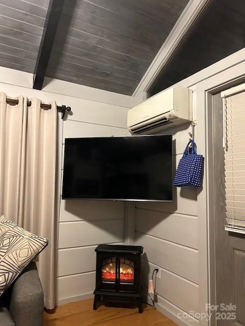 623 Overlook Dr, Spruce Pine, NC 28777 - detailed view of a wood stove, a wall unit AC, wood finished floors, and wood ceiling with exposed beams