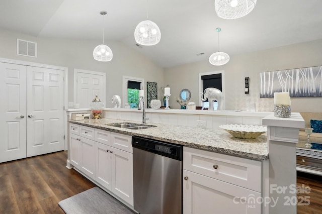204 Craig St, Mount Holly, NC 28120 - kitchen with stainless steel dishwasher, a sink, vaulted ceiling, dark wood-style floors, and white cabinetry