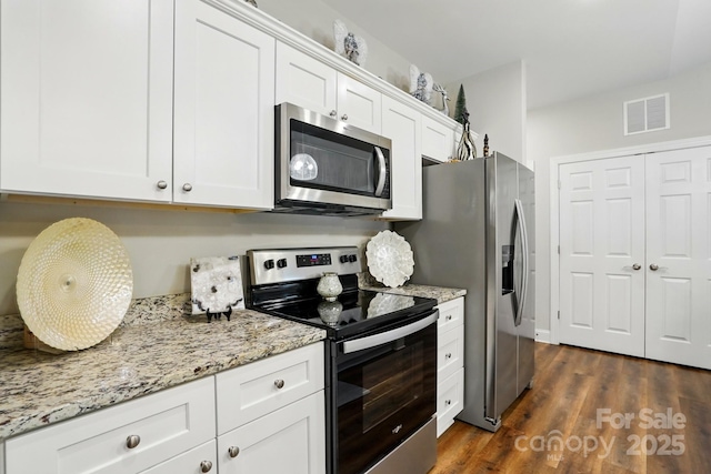 204 Craig St, Mount Holly, NC 28120 - kitchen featuring stainless steel appliances, white cabinets, light stone counters, and dark wood-style flooring