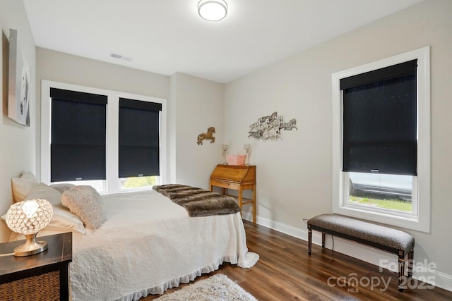 204 Craig St, Mount Holly, NC 28120 - bedroom with dark wood finished floors, multiple windows, and baseboards