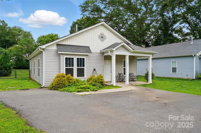 204 Craig St, Mount Holly, NC 28120 - view of front facade featuring a patio, board and batten siding, and a shingled roof