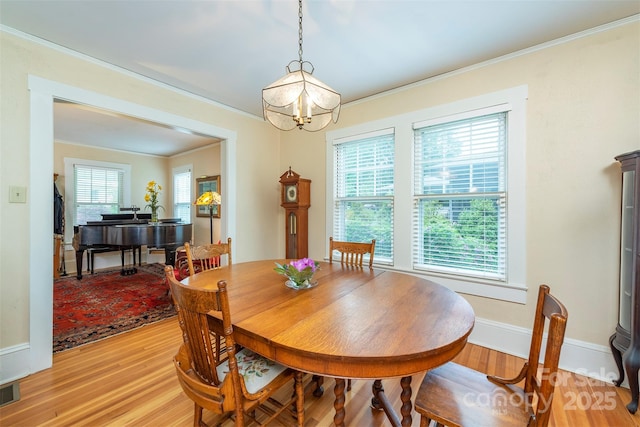 108 Connally St, Black Mountain, NC 28711 - dining space featuring light wood finished floors, a chandelier, and ornamental molding