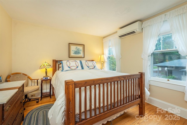 108 Connally St, Black Mountain, NC 28711 - bedroom featuring a wall mounted AC and wood finished floors