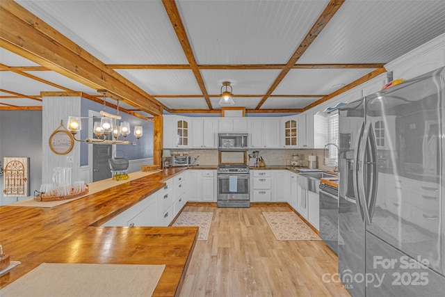 1 Plaza Dr, Granite Falls, NC 28630 - kitchen with appliances with stainless steel finishes, a sink, light wood-type flooring, glass insert cabinets, and coffered ceiling