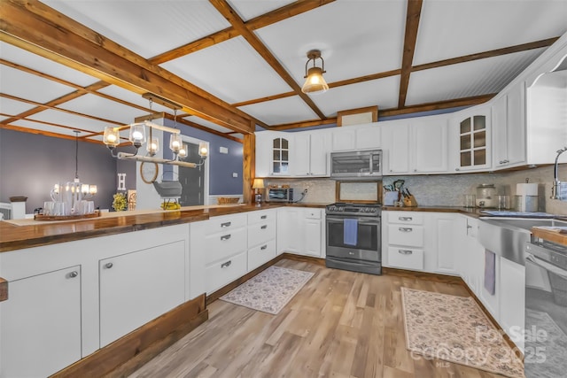 1 Plaza Dr, Granite Falls, NC 28630 - kitchen with appliances with stainless steel finishes, a chandelier, tasteful backsplash, glass insert cabinets, and light wood finished floors