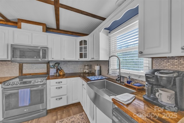 1 Plaza Dr, Granite Falls, NC 28630 - kitchen with stainless steel appliances, a sink, white cabinets, tasteful backsplash, and glass insert cabinets