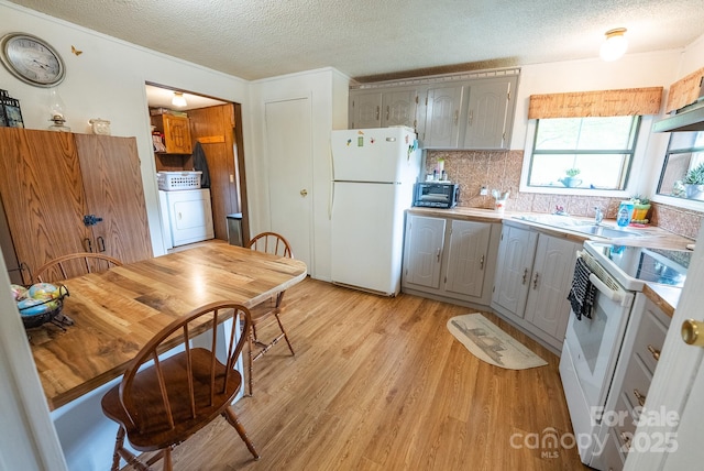 559 Mouth Of Silas Creek Rd, Lansing, NC 28643 - kitchen with white appliances, gray cabinetry, washer / clothes dryer, a textured ceiling, and light wood-style floors