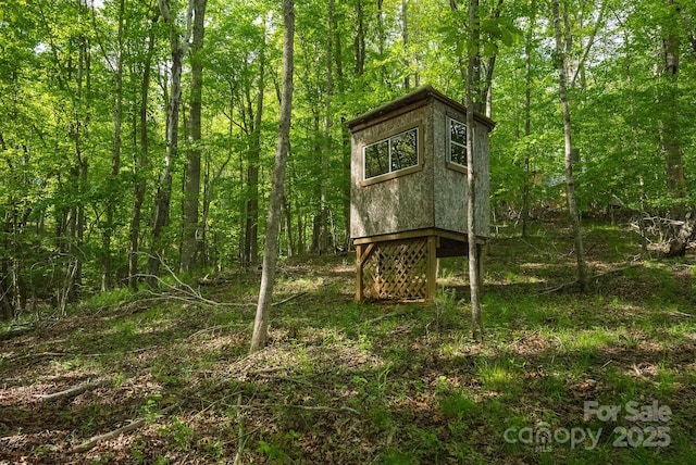 559 Mouth Of Silas Creek Rd, Lansing, NC 28643 - view of outdoor structure featuring a wooded view