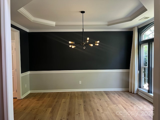 2567 Holly Oak Ln, Gastonia, NC 28056 - unfurnished room featuring a chandelier, a raised ceiling, hardwood / wood-style floors, and crown molding