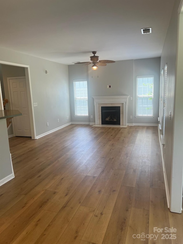 2567 Holly Oak Ln, Gastonia, NC 28056 - unfurnished living room with a ceiling fan, hardwood / wood-style flooring, and a fireplace