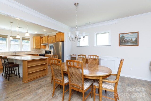 238 Cherrytree Dr, Fort Mill, SC 29715 - dining area featuring a chandelier, crown molding, light wood-type flooring, and baseboards
