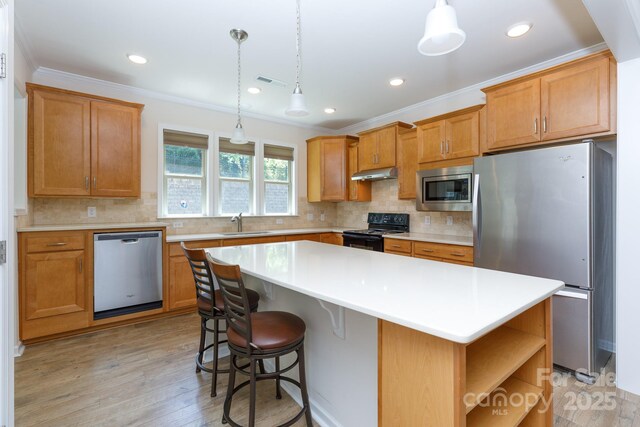 238 Cherrytree Dr, Fort Mill, SC 29715 - kitchen featuring stainless steel appliances, under cabinet range hood, a sink, a kitchen island, and light countertops