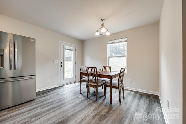 415 Kickapoo Ave, Gastonia, NC 28056 - dining room featuring wood finished floors, a chandelier, and baseboards