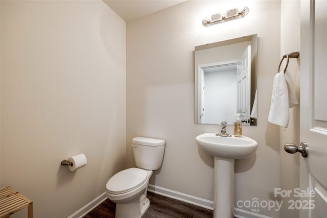 415 Kickapoo Ave, Gastonia, NC 28056 - bathroom featuring toilet, wood finished floors, baseboards, and a sink