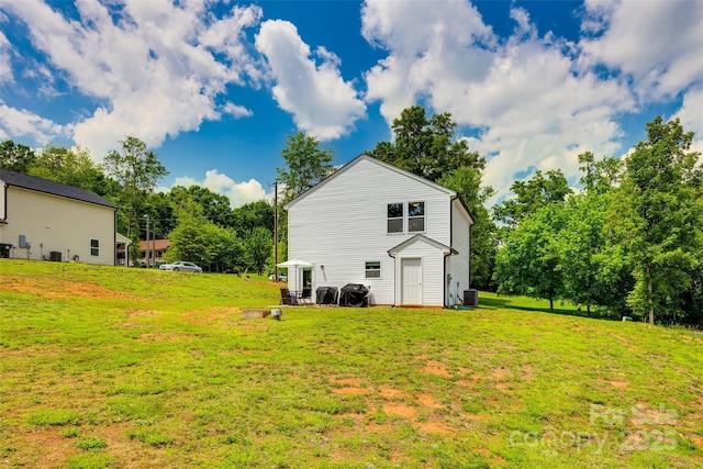 415 Kickapoo Ave, Gastonia, NC 28056 - view of grassy yard featuring central AC and view of scattered trees