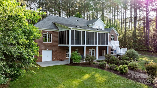 5487 Back Shore Dr, Granite Falls, NC 28630 - rear view of house with a sunroom, a patio area, brick siding, a lawn, and french doors