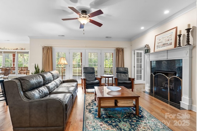 5487 Back Shore Dr, Granite Falls, NC 28630 - living area with crown molding, healthy amount of natural light, a ceiling fan, a fireplace, and light wood-type flooring
