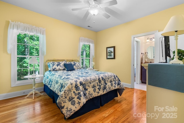 5487 Back Shore Dr, Granite Falls, NC 28630 - bedroom with baseboards, light wood finished floors, a ceiling fan, and ensuite bath