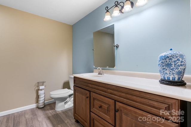 5487 Back Shore Dr, Granite Falls, NC 28630 - bathroom with vanity, toilet, wood finished floors, and baseboards