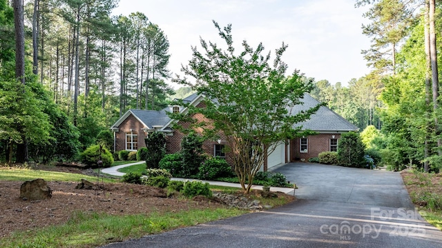 5487 Back Shore Dr, Granite Falls, NC 28630 - view of front of house with brick siding, an attached garage, and concrete driveway