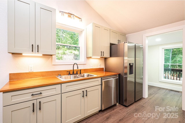 2448 Alfred Hartley Rd, Lenoir, NC 28645 - kitchen featuring appliances with stainless steel finishes, a sink, wood finished floors, wood counters, and vaulted ceiling