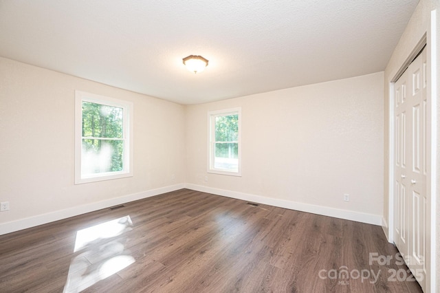 2448 Alfred Hartley Rd, Lenoir, NC 28645 - unfurnished bedroom featuring a closet, dark wood-type flooring, and baseboards