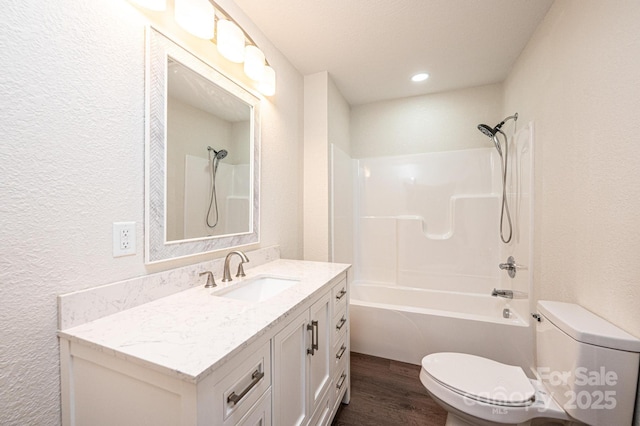 2448 Alfred Hartley Rd, Lenoir, NC 28645 - full bath with toilet, a textured wall, wood finished floors, vanity, and shower / washtub combination
