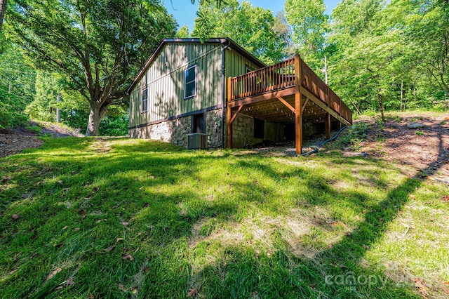 2448 Alfred Hartley Rd, Lenoir, NC 28645 - back of property with a wooden deck, a lawn, stone siding, board and batten siding, and central AC