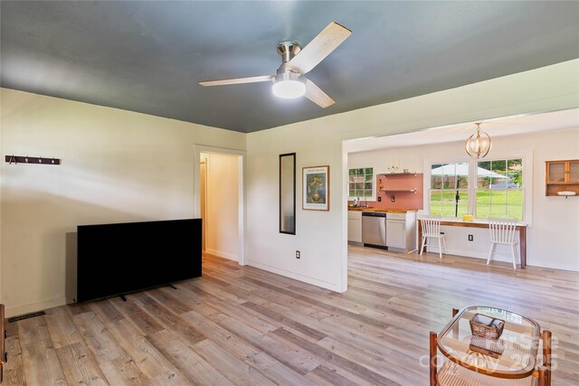 381 Mountain View St, Forest City, NC 28043 - living area featuring light wood-type flooring, a ceiling fan, a chandelier, and baseboards