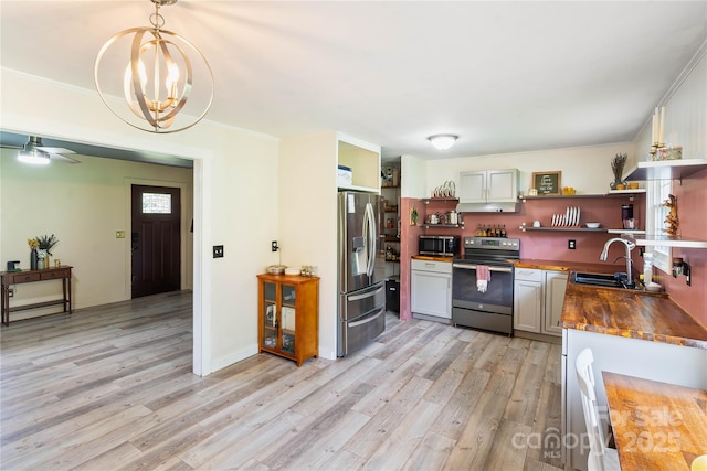 381 Mountain View St, Forest City, NC 28043 - kitchen with appliances with stainless steel finishes, open shelves, a sink, butcher block counters, and light wood-type flooring