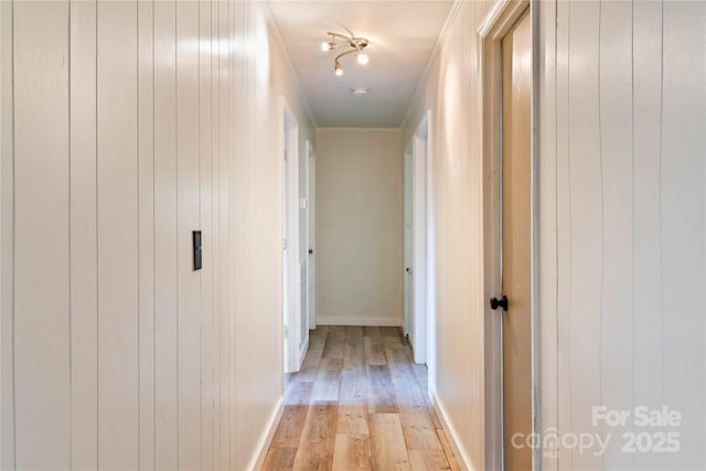 381 Mountain View St, Forest City, NC 28043 - hallway featuring light wood-style flooring, wooden walls, crown molding, and baseboards