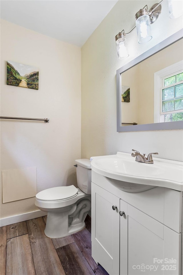 381 Mountain View St, Forest City, NC 28043 - half bath with vanity, wood finished floors, toilet, and baseboards