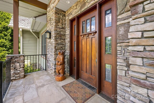 2160 Valle Cay Dr, Vilas, NC 28692 - view of exterior entry with a porch and stone siding