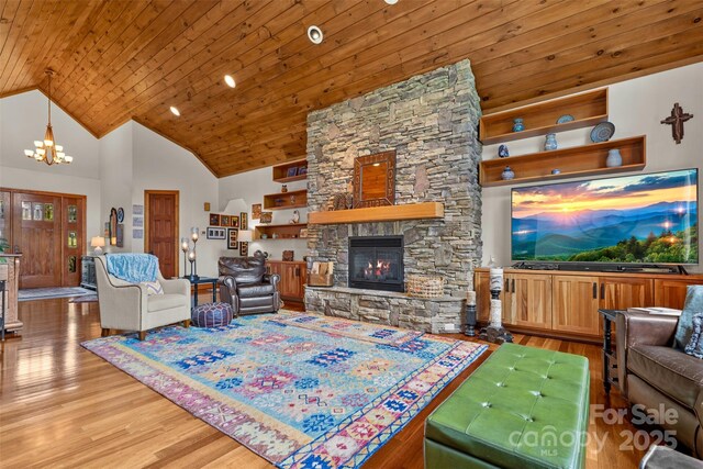 2160 Valle Cay Dr, Vilas, NC 28692 - living room featuring a stone fireplace, wood ceiling, light wood-style flooring, a chandelier, and high vaulted ceiling