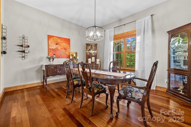 2160 Valle Cay Dr, Vilas, NC 28692 - dining room featuring a chandelier, wood finished floors, and baseboards