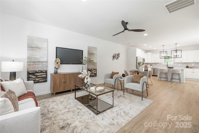 2313 Stallings Rd, Harrisburg, NC 28075 - living area with light wood-style floors, a ceiling fan, recessed lighting, and baseboards
