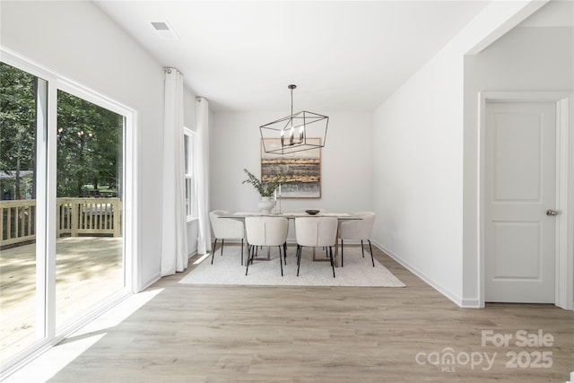 2313 Stallings Rd, Harrisburg, NC 28075 - dining room featuring a chandelier, wood finished floors, and baseboards