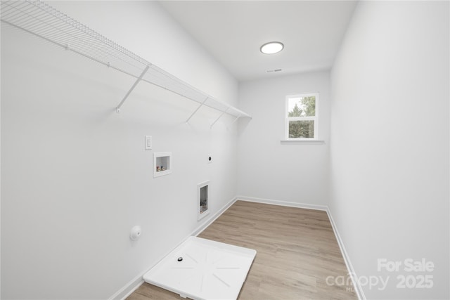 2313 Stallings Rd, Harrisburg, NC 28075 - laundry area with hookup for a gas dryer, hookup for a washing machine, hookup for an electric dryer, baseboards, and light wood-style floors