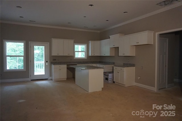 3452 Hands Mill Highway, York, SC 29745 - kitchen featuring a center island, baseboards, white cabinets, ornamental molding, and light colored carpet