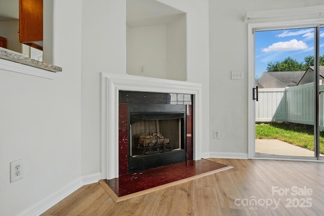 8605 Sawleaf Ct, Charlotte, NC 28215 - detailed view of wood finished floors, a fireplace, and baseboards