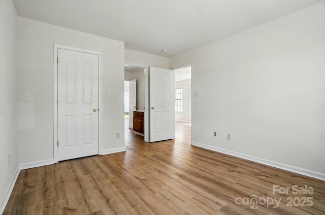 8605 Sawleaf Ct, Charlotte, NC 28215 - unfurnished bedroom featuring light wood-style floors and baseboards