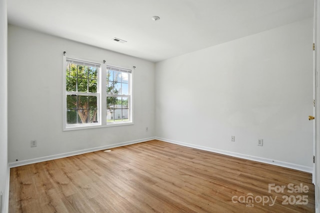 8605 Sawleaf Ct, Charlotte, NC 28215 - unfurnished room with wood finished floors and baseboards