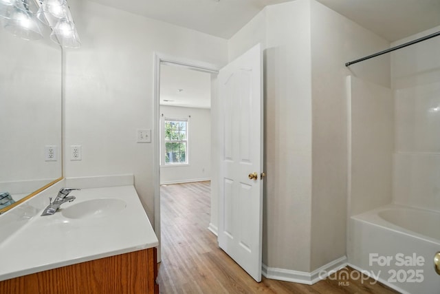 8605 Sawleaf Ct, Charlotte, NC 28215 - full bathroom with vanity, wood finished floors, shower / tub combination, and baseboards