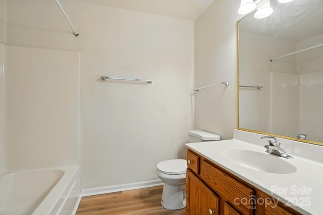 8605 Sawleaf Ct, Charlotte, NC 28215 - full bathroom with toilet, wood finished floors, vanity, washtub / shower combination, and baseboards