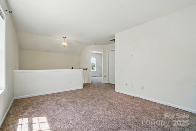 8605 Sawleaf Ct, Charlotte, NC 28215 - carpeted empty room featuring baseboards and a chandelier