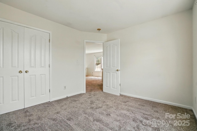 8605 Sawleaf Ct, Charlotte, NC 28215 - unfurnished bedroom featuring carpet flooring, baseboards, and a closet