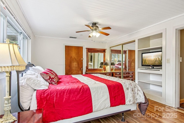 231 Highlands Loop, Maggie Valley, NC 28751 - bedroom with a closet, wood finished floors, ornamental molding, and a ceiling fan